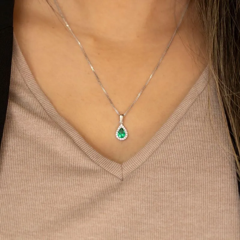 White gold drop necklace with white zircons and a green zircon in the center